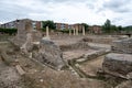 Archaeological ruins of Complutum with modern backdrop Royalty Free Stock Photo