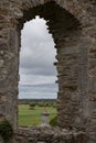 View through an arch in  monastery of Clonmacnoise ruin in Ireland Royalty Free Stock Photo