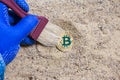 Bitcoin archeology coin in sand.