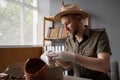 Archaeologist or digger in a hat working in an office, packing antique dishes for sale Royalty Free Stock Photo