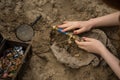 Archaeologist excavates and searches for treasure