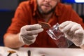 An archaeologist places a found piece of an ancient vessel, close-up. Archaeology, excavation and dig concept