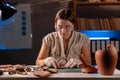 Archaeologist working late at night in her office