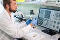 Archaeologist working in natural research lab. Laboratory assistant cleaning animal bones. Archaeology, zoology