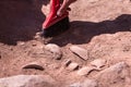 Archaeologist working on site, hand with brush