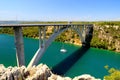 Arched bridge across Krka river in Croatia. Croatian river landscape in spring and summer, Europe. Automobile bridge Royalty Free Stock Photo