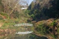 Arched bridge spanning the tranquil lake Royalty Free Stock Photo