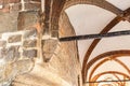 The arched ceiling of a building is made of stone in Lubeck Germany. The arches are brown and white Royalty Free Stock Photo
