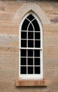 Arched church window set in sandstone bricks