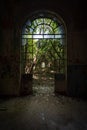 Arched door with broken windows in an old dilapidated Italian building Royalty Free Stock Photo