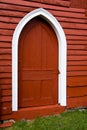 Arched door in old red wooden barn. Royalty Free Stock Photo