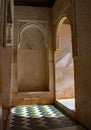 Sunlit doorway with mosaic tiled floor of green, blue and white.