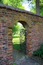 Arched doorway in old brick wall