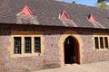 The arched doorway into the visitor centre at an English country home. They are converted stables around a large courtyard Royalty Free Stock Photo