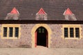 The arched doorway into the visitor centre at an English country home. They are converted stables around a large courtyard Royalty Free Stock Photo