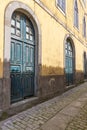 Arched doorways on a building along a narrow street in Caminha
