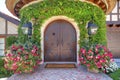 Arched double doors in a house with vines on the wall at La Jolla, California