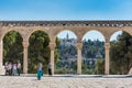 Arched East gateway and tourists at the square of Golden Dome of the Rock, an Islamic shrine located on the Temple Mount in the