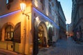 Arched entrance door and window of cafe restaurant in city at night with offerings signs on street Royalty Free Stock Photo