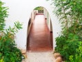 Arched entrance with some greenery. Archway to the rooms at the resort