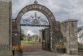 Arched entrance to a churchyard with metal gate