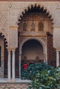 Arched entrance to Patio de Maidens courtyard inside Alcazar of Seville, Spain, tourist walk on background Royalty Free Stock Photo
