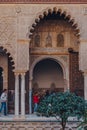 Arched entrance to Patio de Maidens courtyard inside Alcazar of Seville, Spain, tourist walk on background Royalty Free Stock Photo