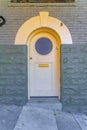 Arched front door with arched doorframe and round panel in San Francisco, California