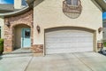 Arched garage door and arched stone entryway of home with glass paned front door Royalty Free Stock Photo