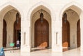 Arched gates and carved wooden doors leading to the Sultan Qaboos Grand Mosque, Oman, Middle East