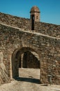 Arched gateway in the city outer wall made of rough stone Royalty Free Stock Photo