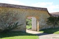 An arched gateway with an old wooden door leads in to the kitchen garden in an old English country manor house Royalty Free Stock Photo