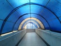 Arched hallway with a translucent blue and white plastic canopy covering Royalty Free Stock Photo
