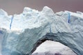 Arched iceberg in the frigid waters of Antarctica Royalty Free Stock Photo