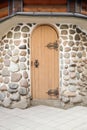 Arched medieval wooden door in a stone wall