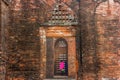 Arched niches on a brick wall in the ancient ruins of the Adina Masjid mosque in the