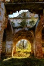 An arched passage in an abandoned temple with a collapsed roof. At the end of the passage is the light of hope. Royalty Free Stock Photo
