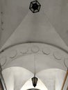 an arched passage with an antique hanging lantern with a decorative element in the form of a row of octagonal recesses Royalty Free Stock Photo