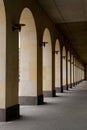 An arched passage near the building. Light passes through the arches.