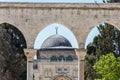 Arched South gateway with Siliver dome of Al-Aqsa Mosque at the square of Golden Dome of the Rock, in an Islamic shrine located on