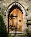 Arched Stone Doorway with Closed Wooden Door Royalty Free Stock Photo