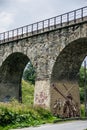 Arched stone railway bridge with street art