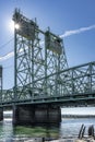 Arched transport truss drawbridge over the Columbia River with towers for raising the section illuminated by sunbeams