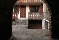 Arched view of old house with wooden balcony,Bormio, Italy Royalty Free Stock Photo