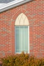 Arched window of a church with red brick wall Royalty Free Stock Photo