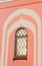 Arched window with openwork wrought iron bars