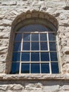 Arched window and rusticated stone masonry