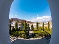 Arched window with view to autumnal alpine landscape, bright sunshine