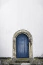 Arched wooden door. Old blue door and a white wall. Just a door Royalty Free Stock Photo