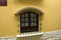 Arched wooden window with metal grating. La Paz, Bolivia